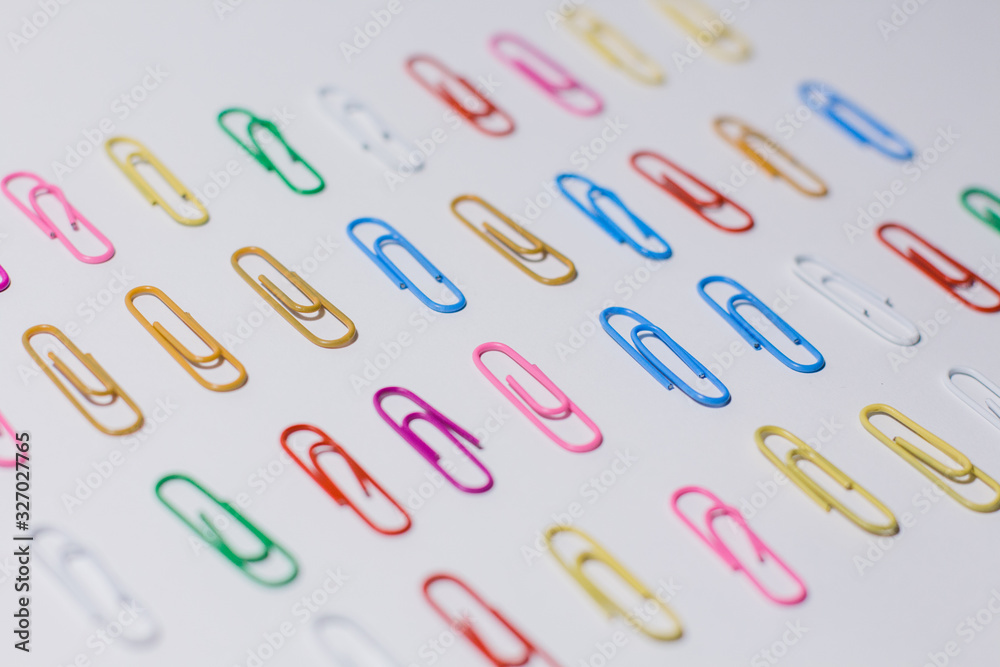 multicolored paper clips on a white background multicolored paper clips on a white background