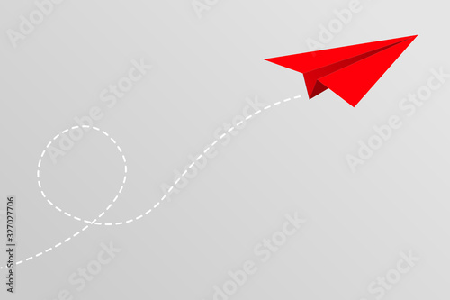 Red paper plane flying on gray sky background