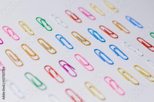 multicolored paper clips on a white background