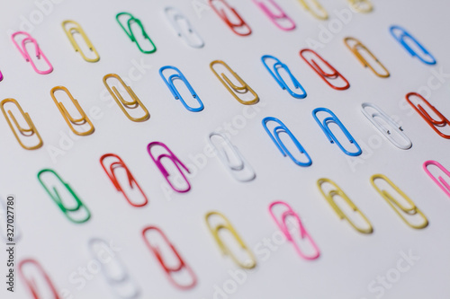 multicolored paper clips on a white background