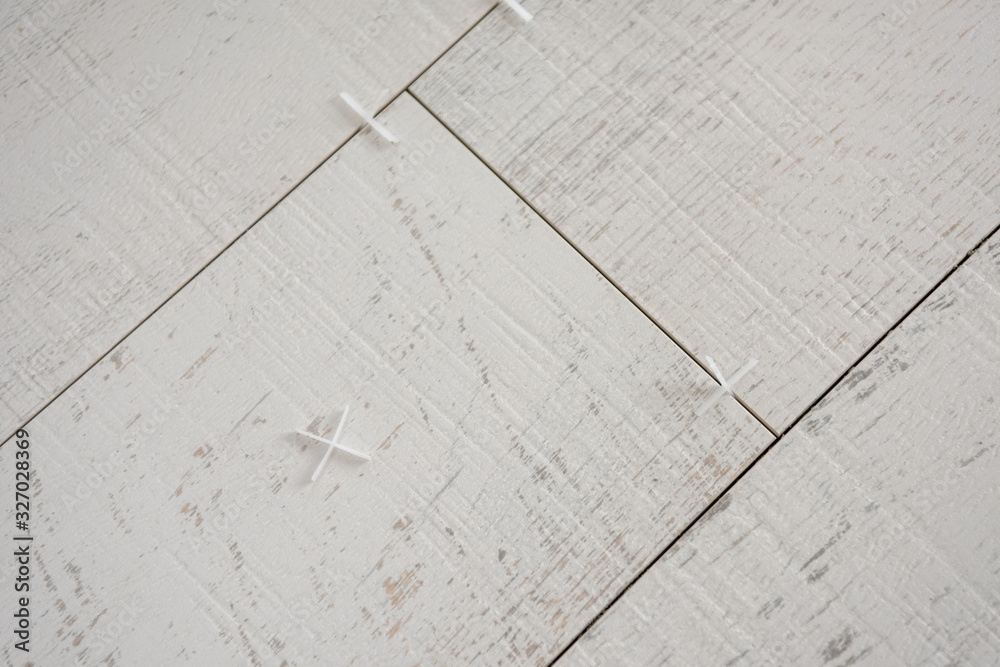 Ceramic wood effect tiles and tools for tiler on the floor Ceramic wood effect tiles and tools for tiler on the floor