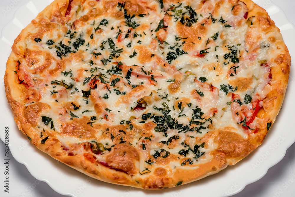 Delicious Italian pizza with olives and greens on a light background top view