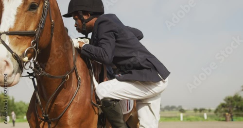 African American man going on his Dressage horse photo