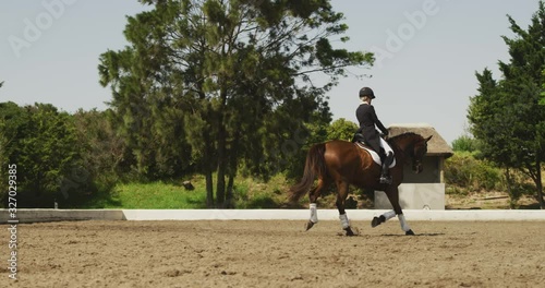 Caucasian woman riding her horse