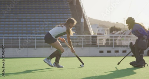 Female hockey players playing on the field photo