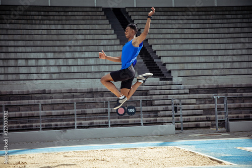 Athlete doing a long jump photo