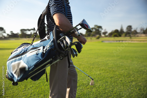 Golfer walking with golf bag
