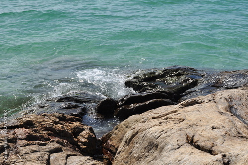 Sea water with waves and rocks at the beach