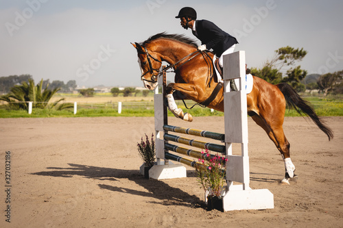 Man jumping with his dressage horse on a show jumping event  photo