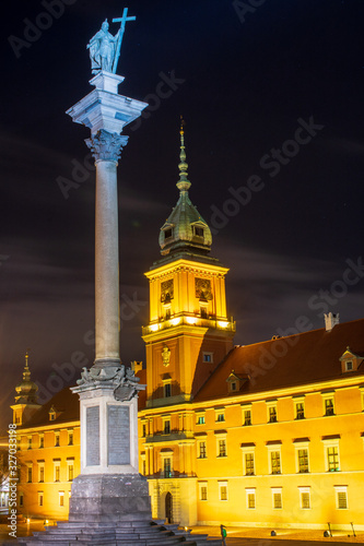 Streets of Warsaw Old Town by the night. Zygmunt Column and Royal Castle.