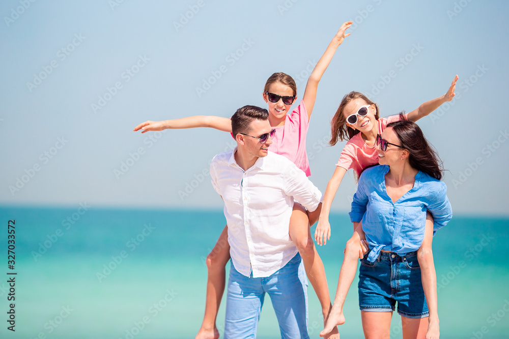 Young family of four on beach vacation Young family of four on beach vacation