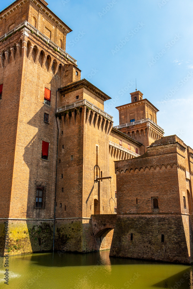 Castello Estense or Este castle exterior partial view with moat in Ferrara, Emilia-Romagna, Italy