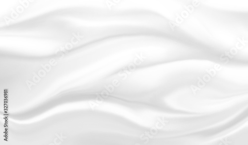 White silk material background texture in luxury elegant draped fabric folds or smooth fancy satin cloth with flowing wavy abstract design