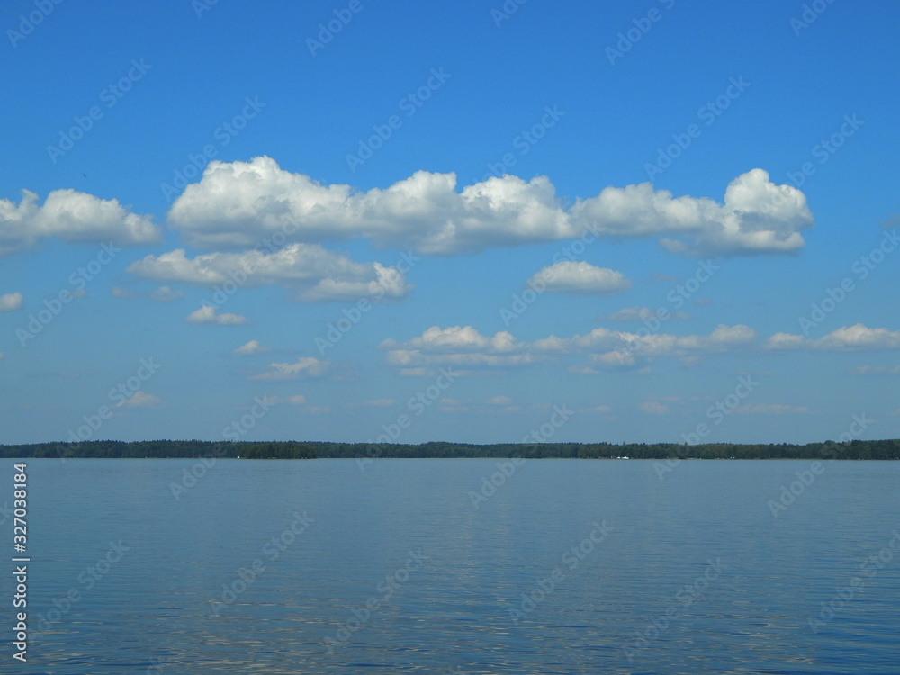 Water, blue sky and clouds - a summer peaceful landscape
