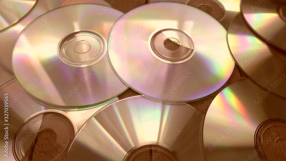 Flying over pile of cd-rom disks lying on floor.