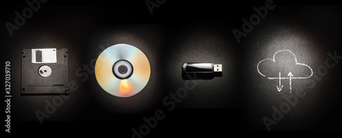 Fényképezés Composition on a black background from a floppy disk, a laser disk, a USB flash drive and a cloud storage symbol