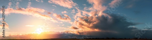 sunset panorama with large clouds on a background of blue sky © Taras Rudenko
