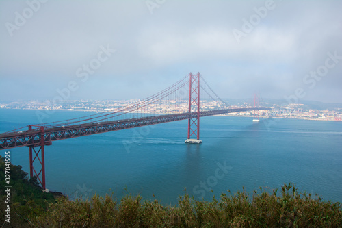 view of 25 de Abril Bridge in Lisbon, Portugal. Ponte 25 de abril. a suspension bridge connecting the city of Lisbon, capital of Portugal, to the municipality of Almada