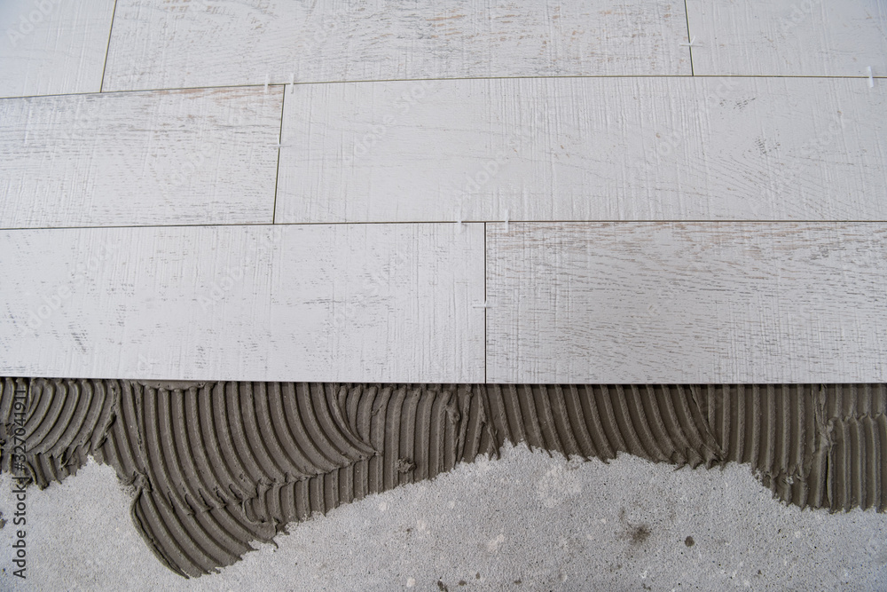 Ceramic wood effect tiles and tools for tiler on the floor Ceramic wood effect tiles and tools for tiler on the floor
