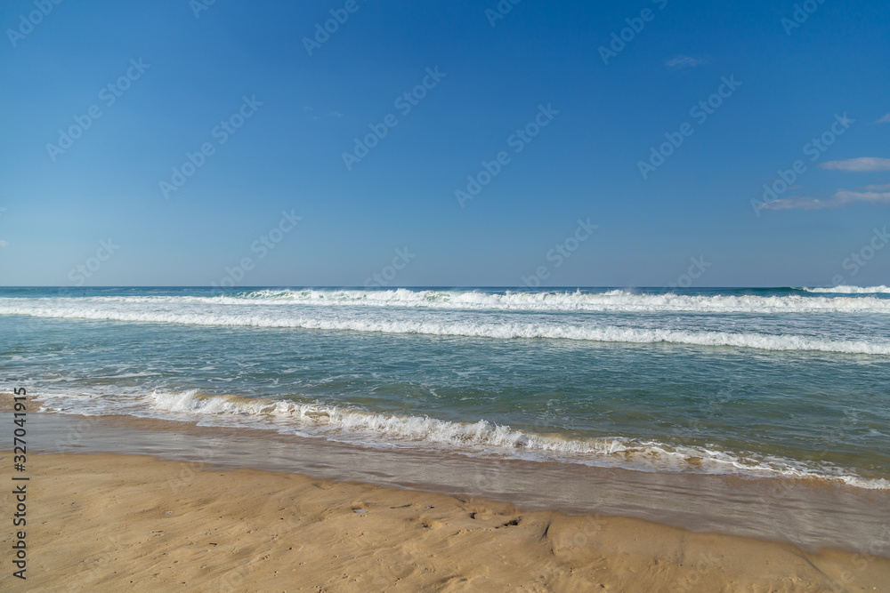 looking out at the ocean with waves rolling in on sunny summers afternoon