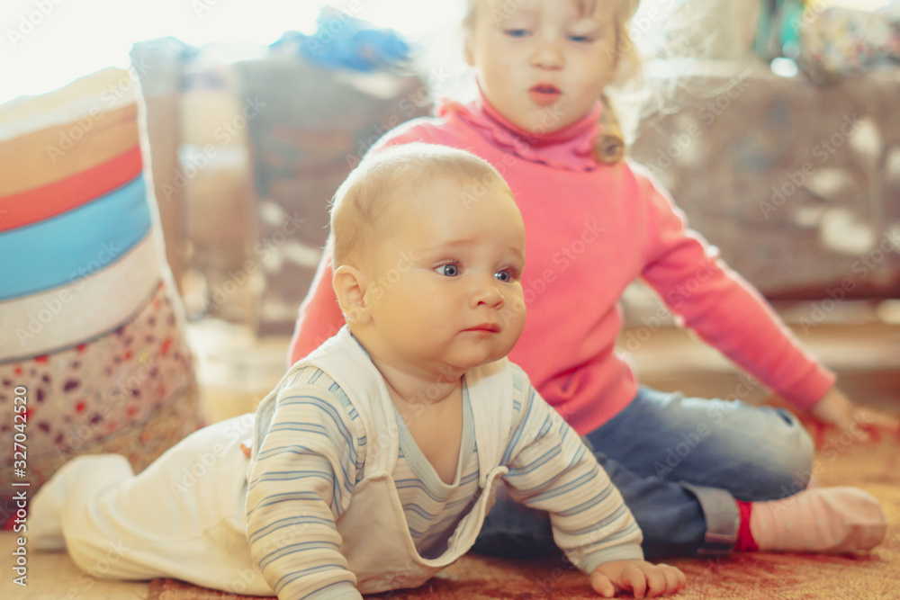 a child crawls on the floor in an apartment a child crawls on the floor in an apartment