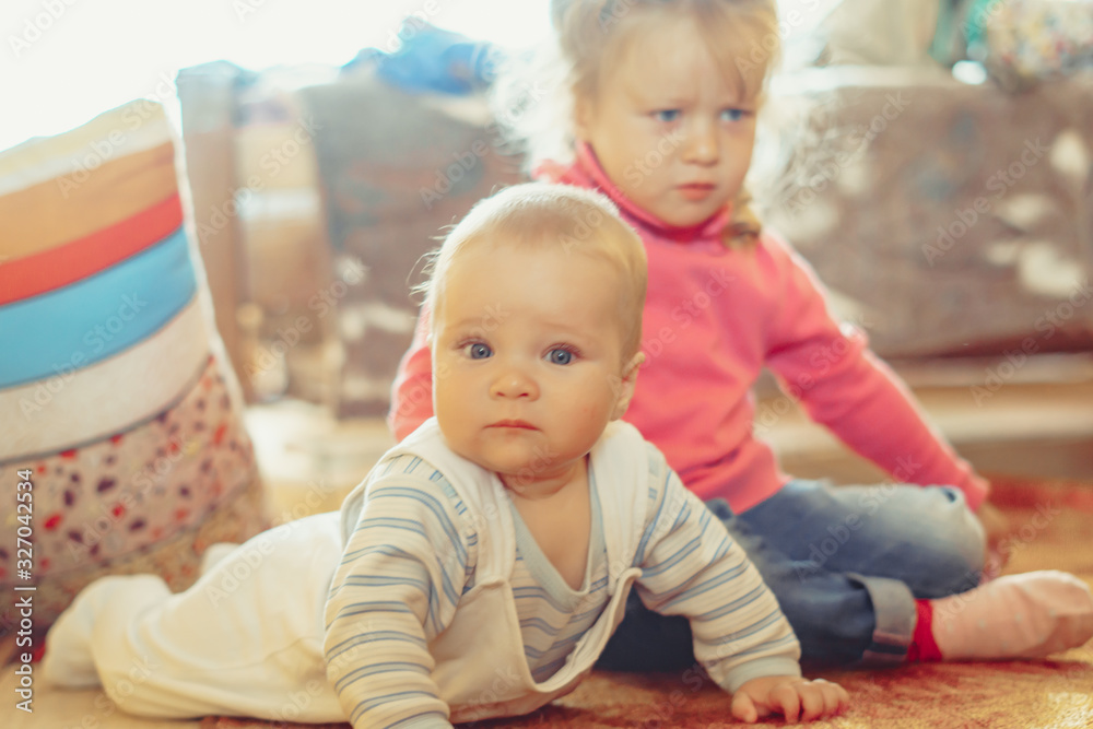 a child crawls on the floor in an apartment a child crawls on the floor in an apartment