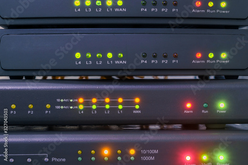 Devices for voice ip Internet connection are in racks. Technology concept. Network telephone routers are close-ups. Telecommunication equipment works in the server room of the data center.