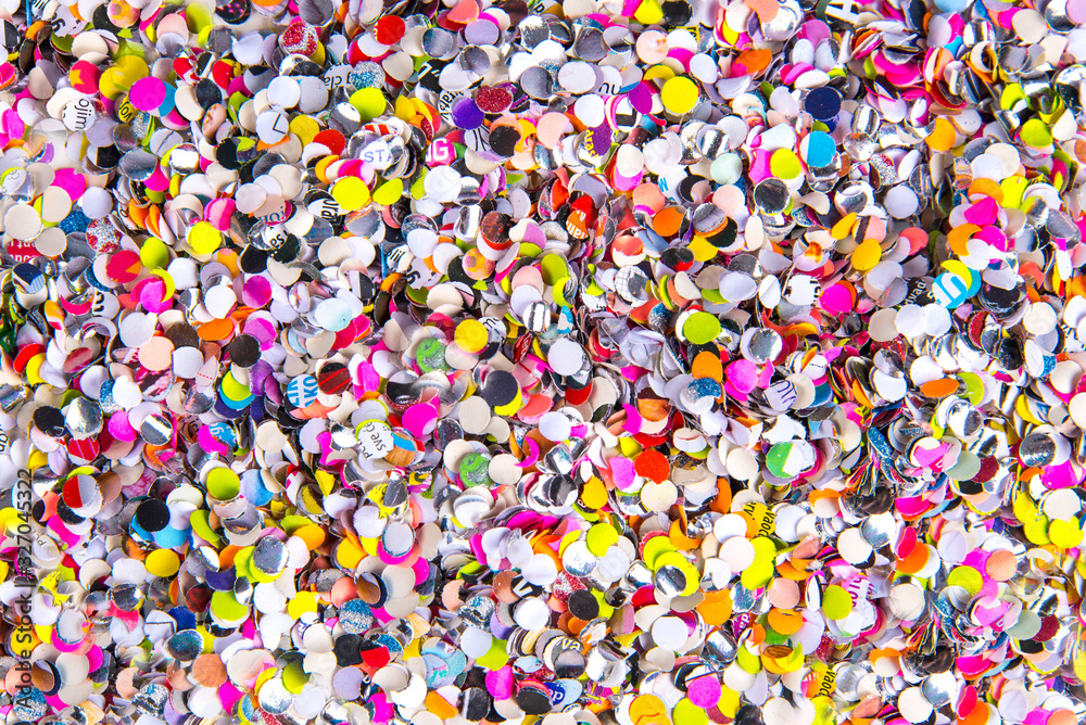 Confetti close up, various colors of round cut paper party confetti, horizontal background