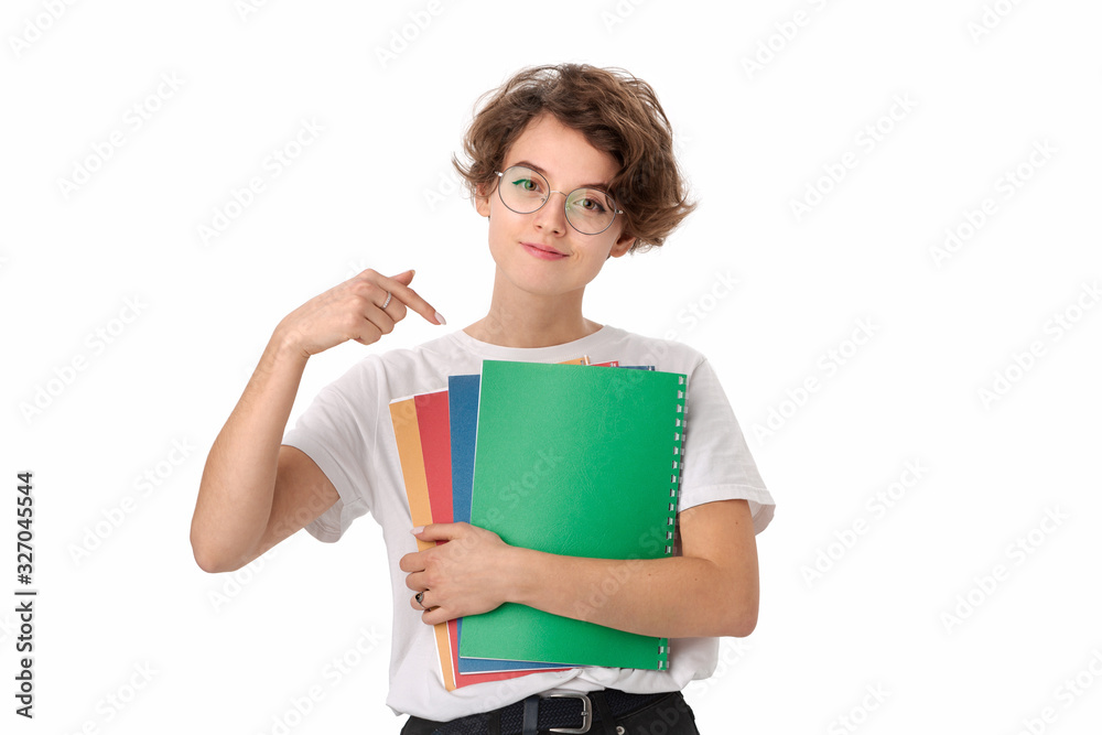 Female student in a white shirt and eyeglasses pointing at colorful folders Female student in a white shirt and eyeglasses pointing at colorful folders