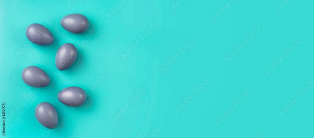 Top view of simple compositon with blue Easter eggs on aqua-mint background Top view of simple compositon with blue Easter eggs on aqua-mint background