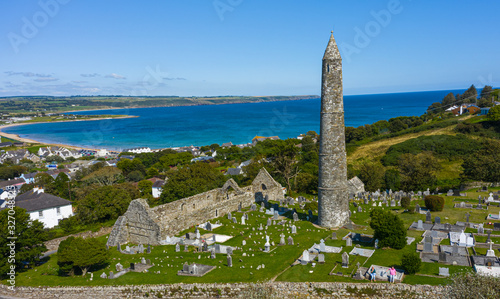 Vászonkép Aerial view of Ardmore Round Tower, Built in the 12h century, the tower stand tall over looking the coastal village of Ardmore