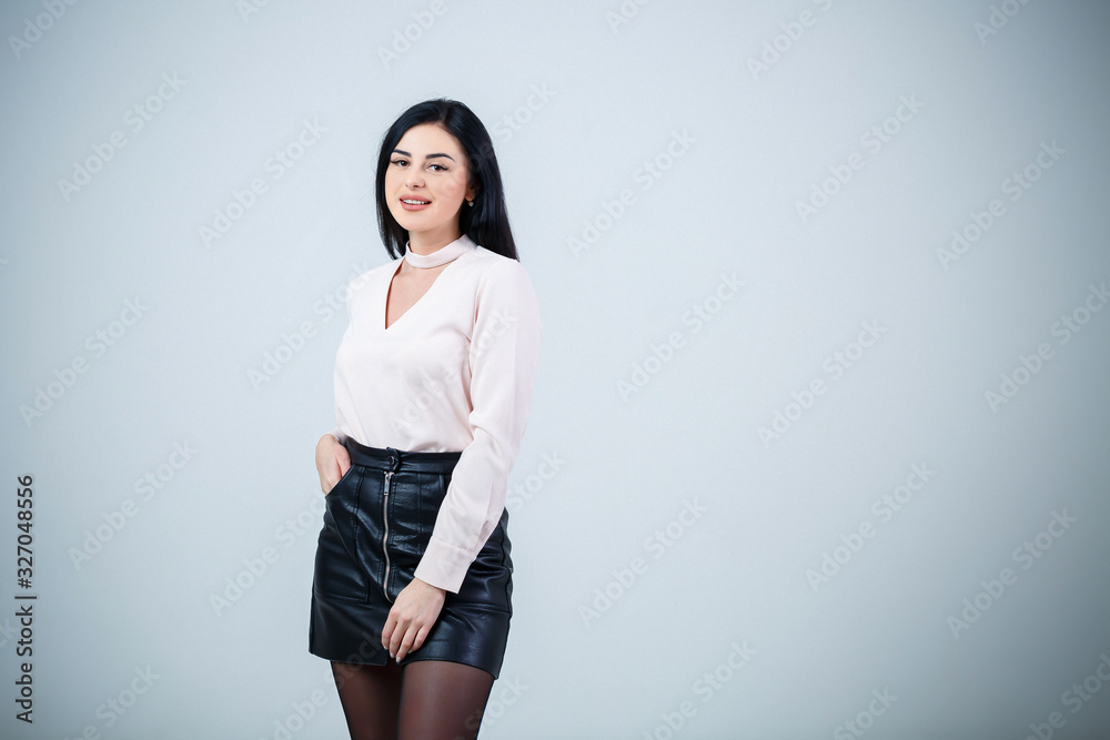 Beautiful girl in white blouse and black leather skirt Beautiful girl in white blouse and black leather skirt