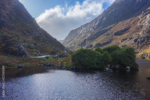 The Gap of Dunloe is a narrow mountain pass running north-south in County Kerry, Ireland, that separates the MacGillycuddy's Reeks mountain range in the west, from the Purple Mountain Group range. photo