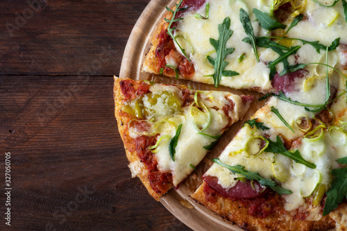 Fotografie Part of a low carb pizza with crust from shredded cauliflower, topped with salam