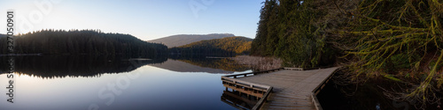 Beautiful and Vibrant Trail in the Green Woods with fresh trees near a lake during sunset. Taken in White Pine Beach, Port Moody, Vancouver, British Columbia, Canada. Panorama