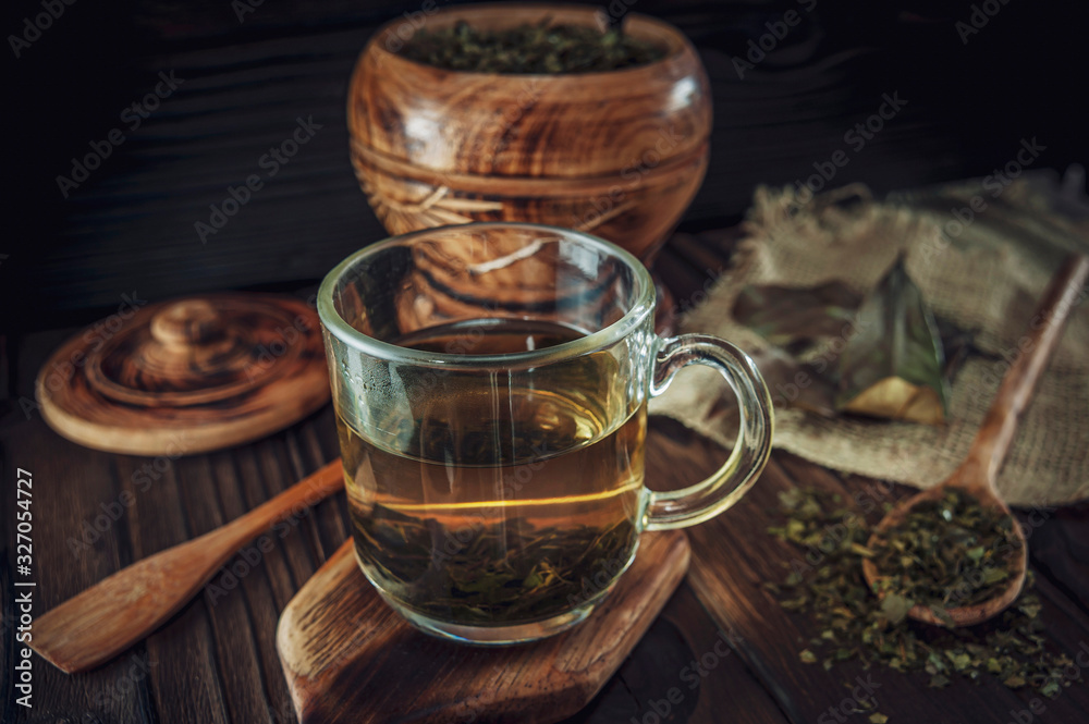 A cup of medicinal soursop tea with dried soursop leaves. A cup of medicinal soursop tea with dried soursop leaves.
