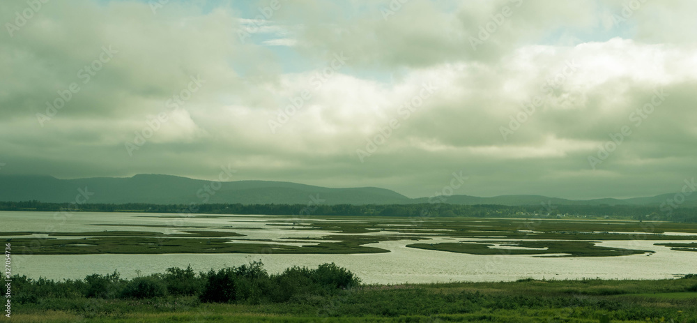 landscape with a stream. landscape of the gaspésie. Landscape with water and grass landscape with a stream. landscape of the gaspésie. Landscape with water and grass