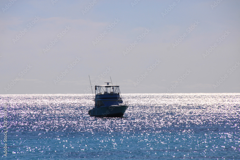 Beautiful modern yacht, ship at sea with tourists on a board.