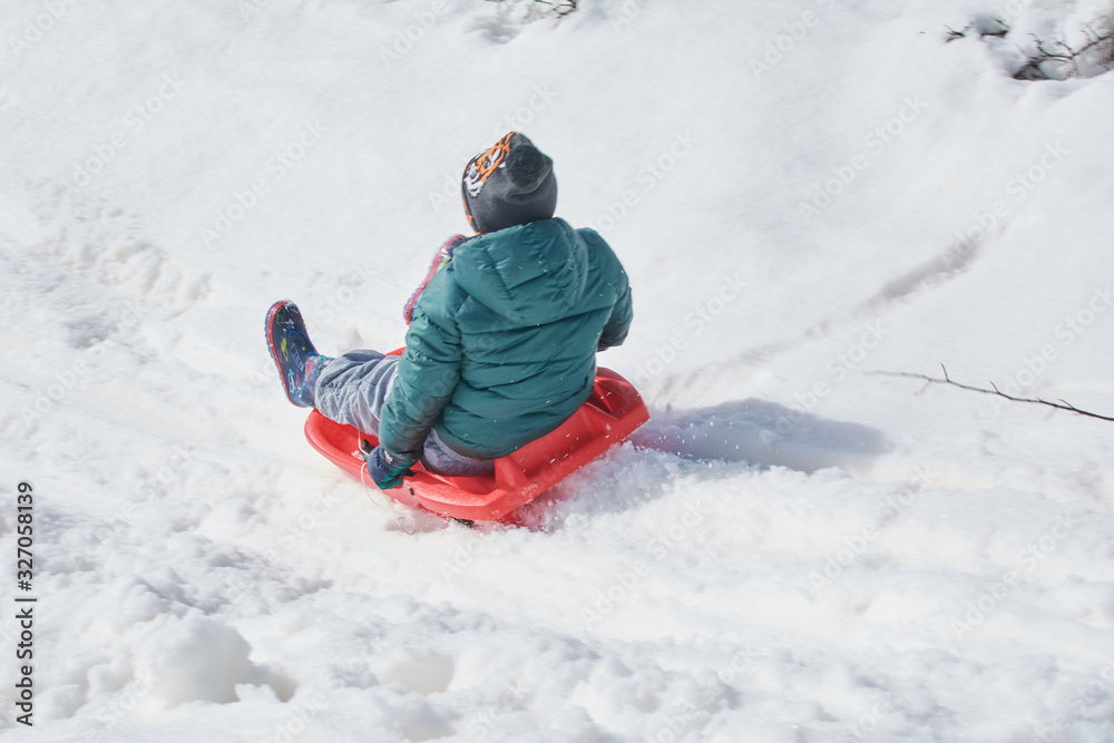 Playing with the sled in the snowy mountain