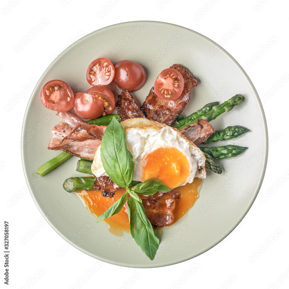 Fried eggs with prosciutto, asparagus and tomato on plate isolated on white, top view. Fried eggs with prosciutto, asparagus and tomato on plate isolated on white, top view.