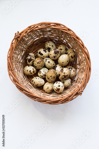 quail eggs in a wicker basket. Easter and easter decoration