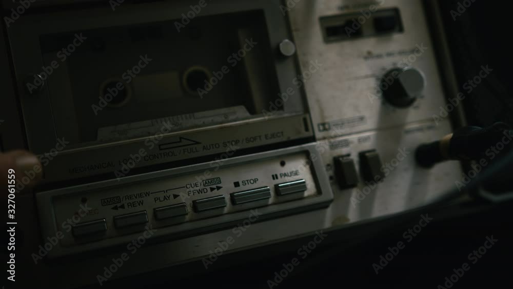 The old cassette player puts a cassette into the boombox, inserts a jack into the headphone jack and presses the record button.