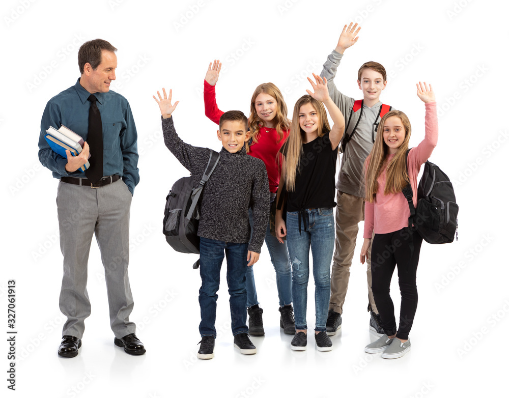 Male Teacher Standing With Stack Of Books Looks To Side At Students