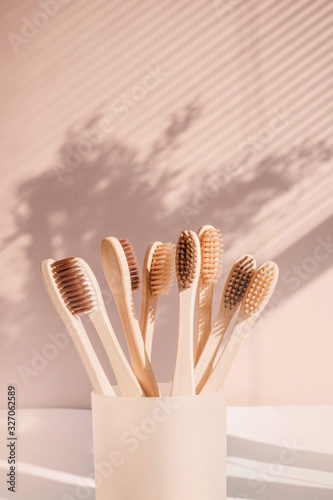 Zero waste bamboo toothbrush on pastel background with floral shades