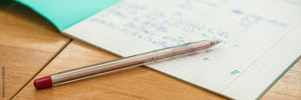 image of a pen on a school notebook