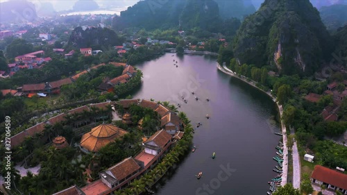 Top down aerial view of rowing boats taking tourists around the sights of Ninh Binh, Northern Vietnam near the small village of Tam Coc. October 2019