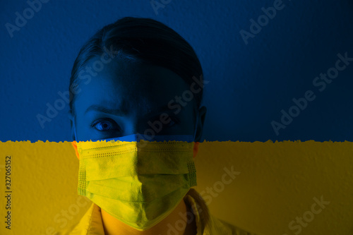 Masked girl, coronary virus disease, new pneumonia. Global outbreak in China. Against the background of the Ukraine flag.