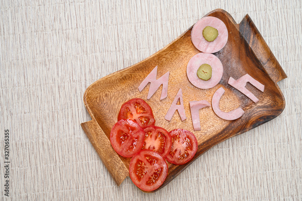 March 8. Number 8 on wooden board. international women day. sausage as a figure eight on wooden board March 8. Number 8 on wooden board. international women day. sausage as a figure eight on wooden board