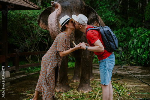Photography Couple in honeymoon playing with an elephant in Bali