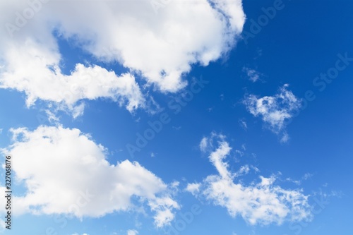 Sky background. Blue sky with fluffy white clouds. Copy space